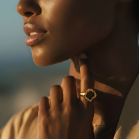 Close-up of a woman wearing a gold earring with a blurred background