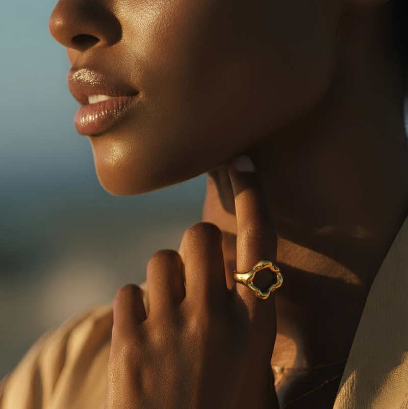 Close-up of a woman wearing a gold earring with a blurred background
