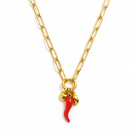 Gold chain necklace with red cornicello charm plus gold heart and bead accents, shown on model.